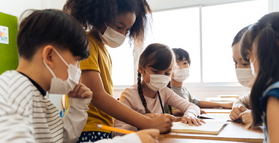 picture of a group of students in a classroom with face masks on