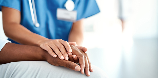 picture of a nurse holding a patient's hand