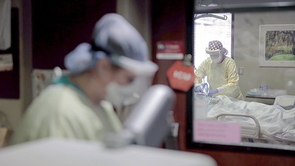 Nurses in full personal protective equipment treating patients in 7UT, one of the 10 COVID-19 units at Nebraska Medical Center.