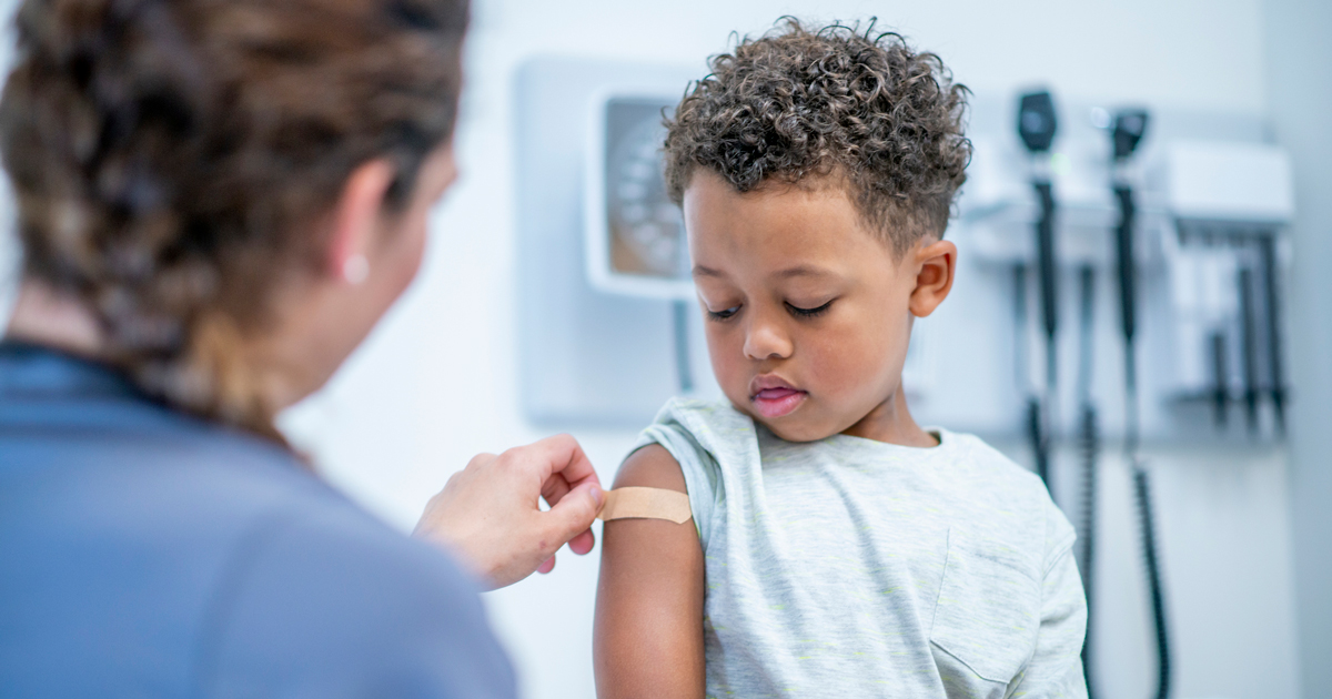 Young child receiving bandaid