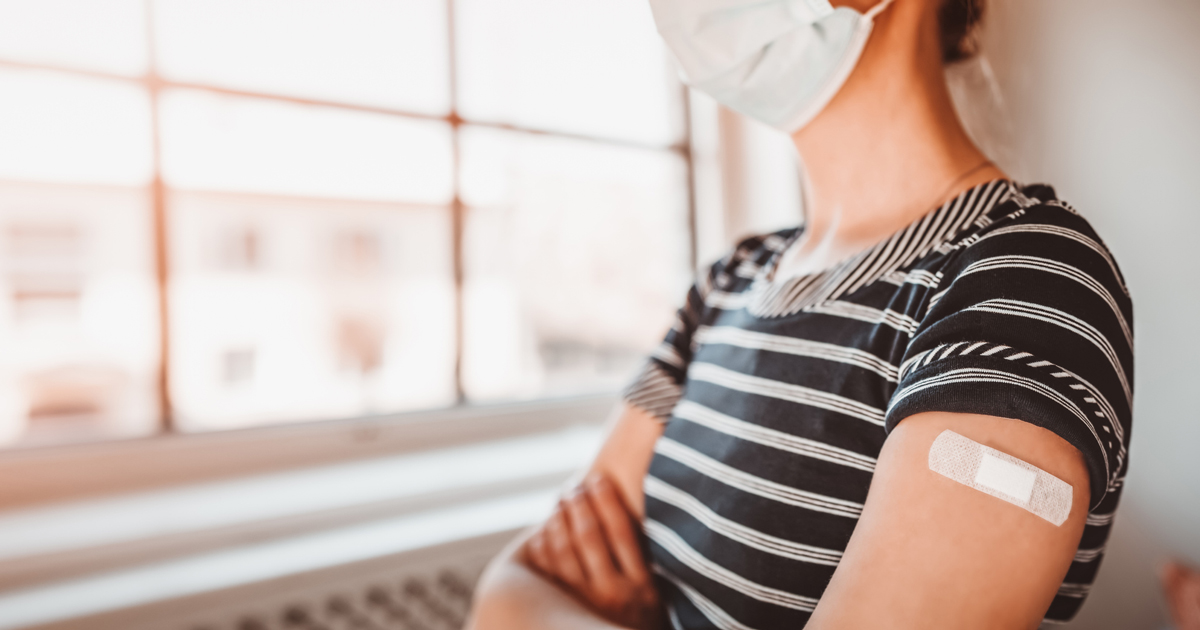 Woman with bandaid on her arm