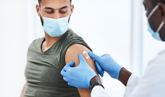 picture of a young man getting his COVID-19 vaccine