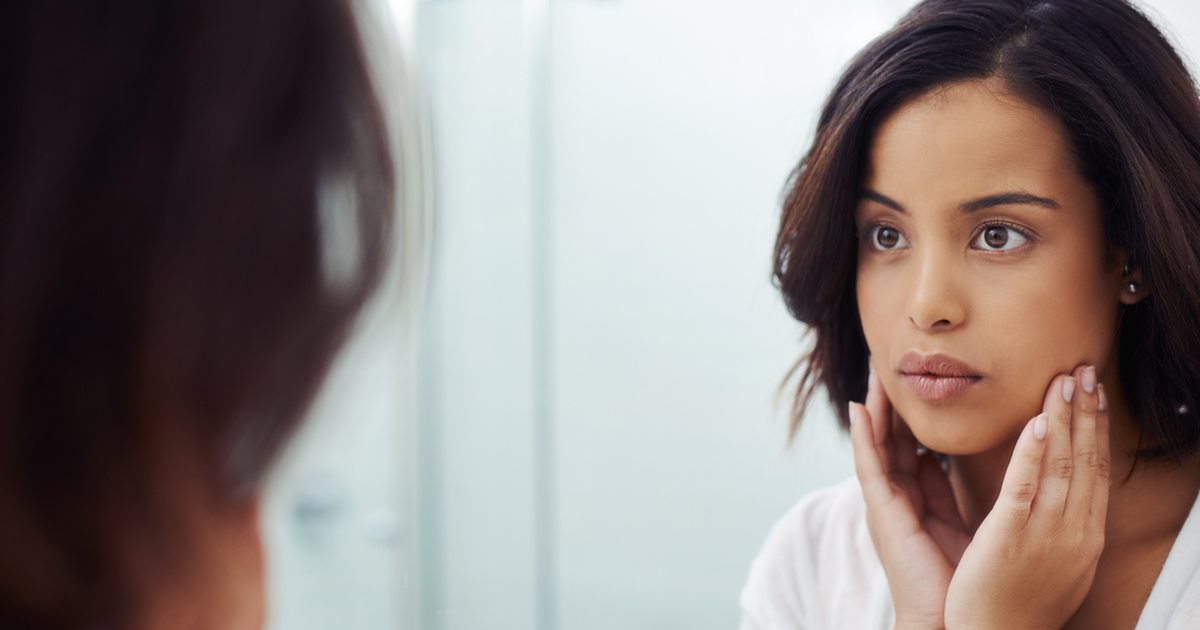 picture of a woman looking at herself in a mirror