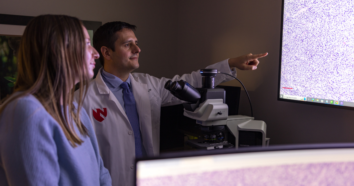 Patient with Corey Georgesen, MD who is pointing at screen