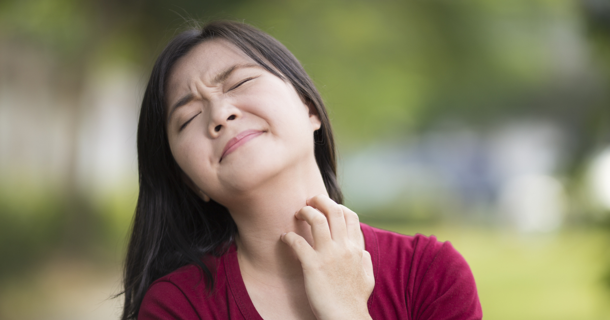 Woman scratching her neck