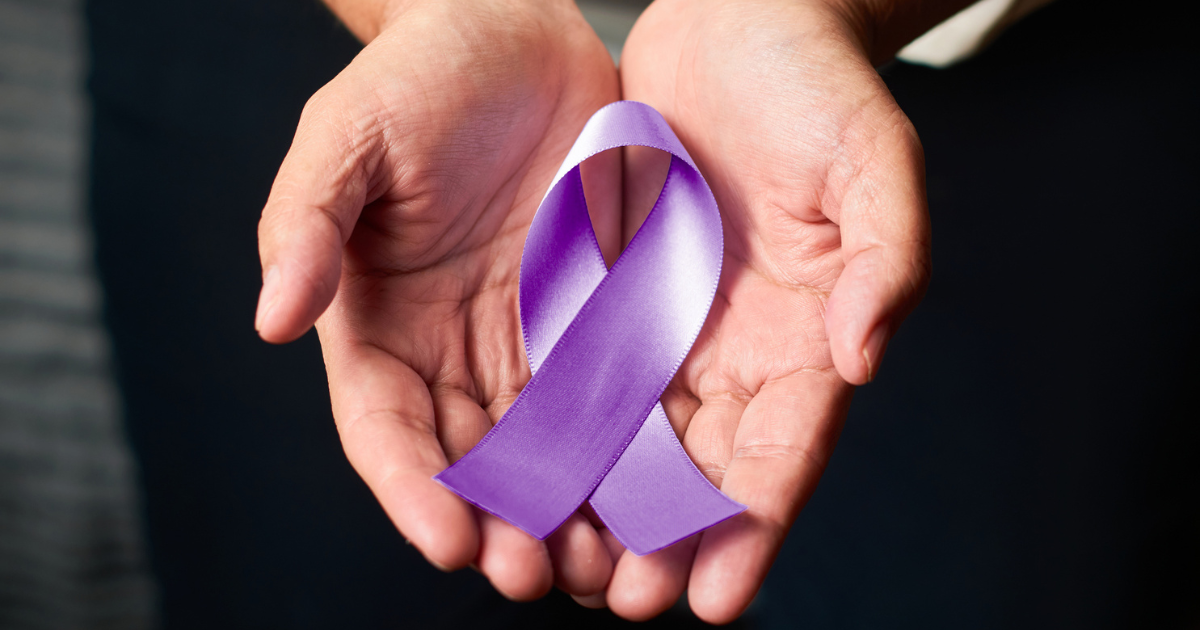 Woman holding purple ribbon
