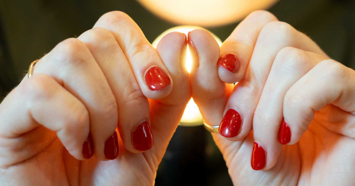 Woman holding her thumb nails together