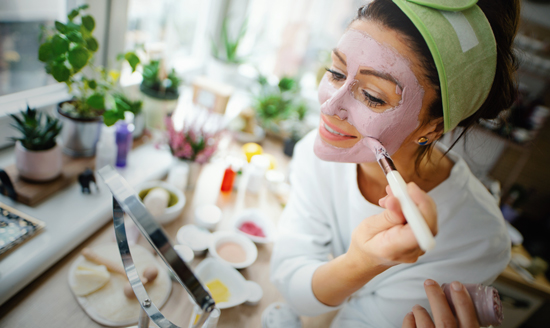 picture of a woman applying a facial mask