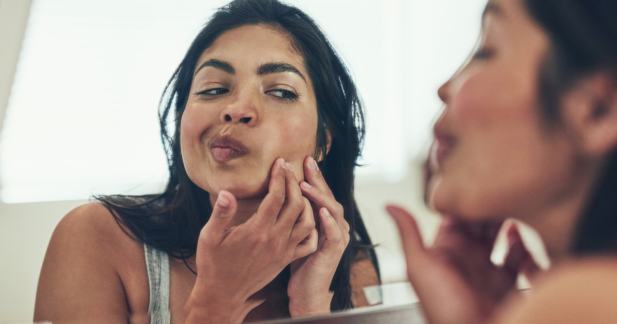 Woman squeezing pimple