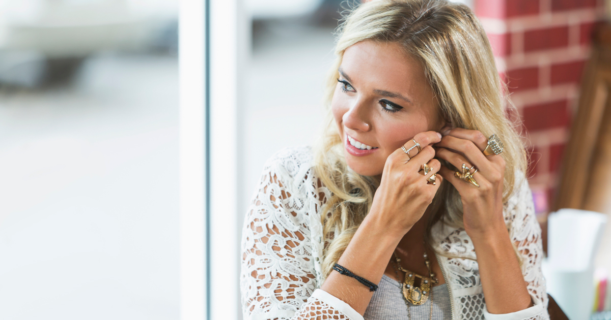 Woman adjusting earring