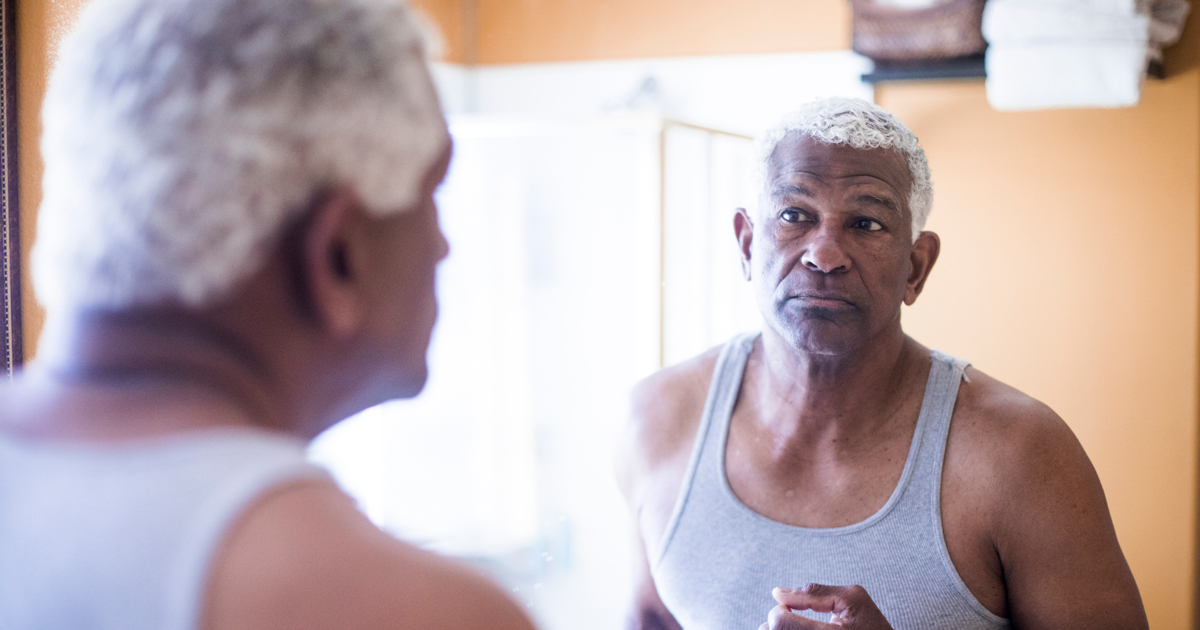 picture of man looking at himself in a mirror