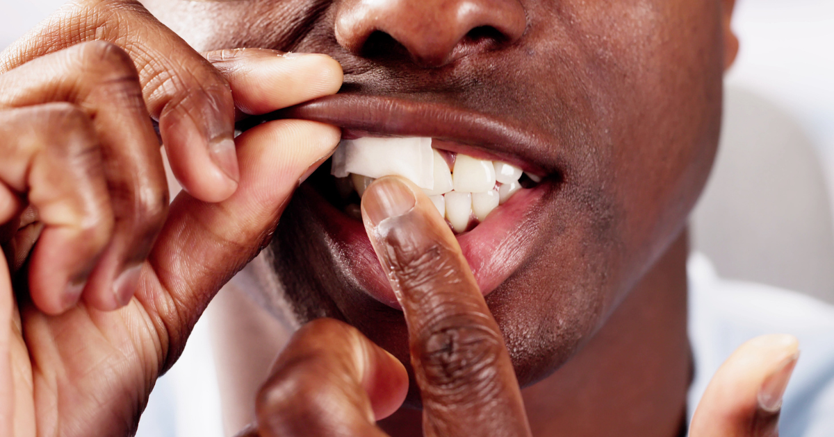 Close up of man putting nicotine pouch in mouth