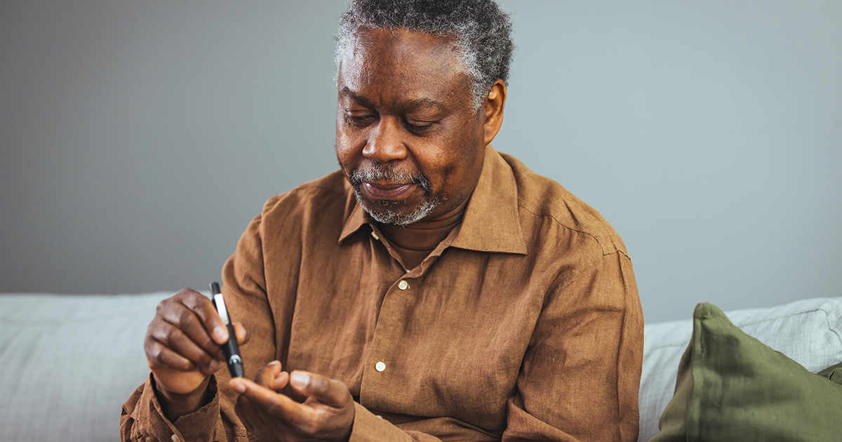 picture of a man checking his blood sugar