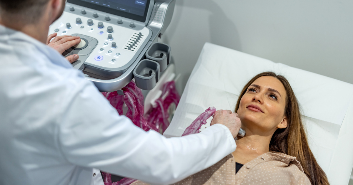 Doctor using ultrasound machine on woman's neck