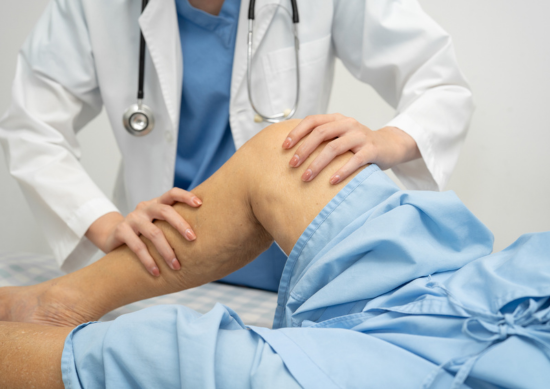 Close up of doctor examining woman's knee