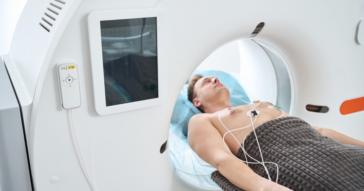 Man lying in CT machine