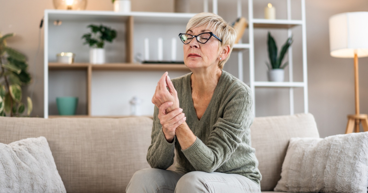 Older woman holding her wrist in pain