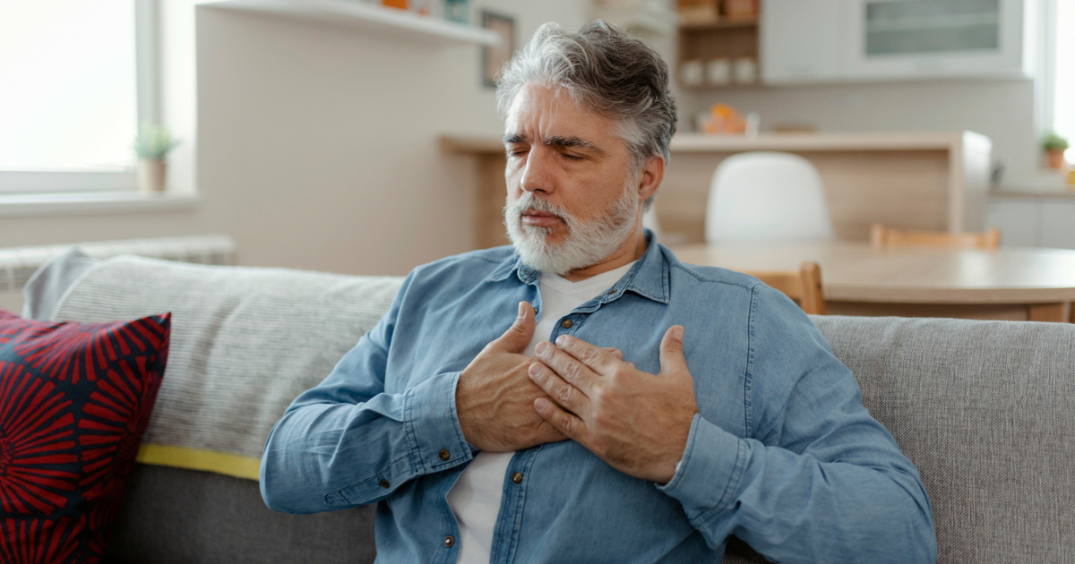 Man holding his hands on his chest