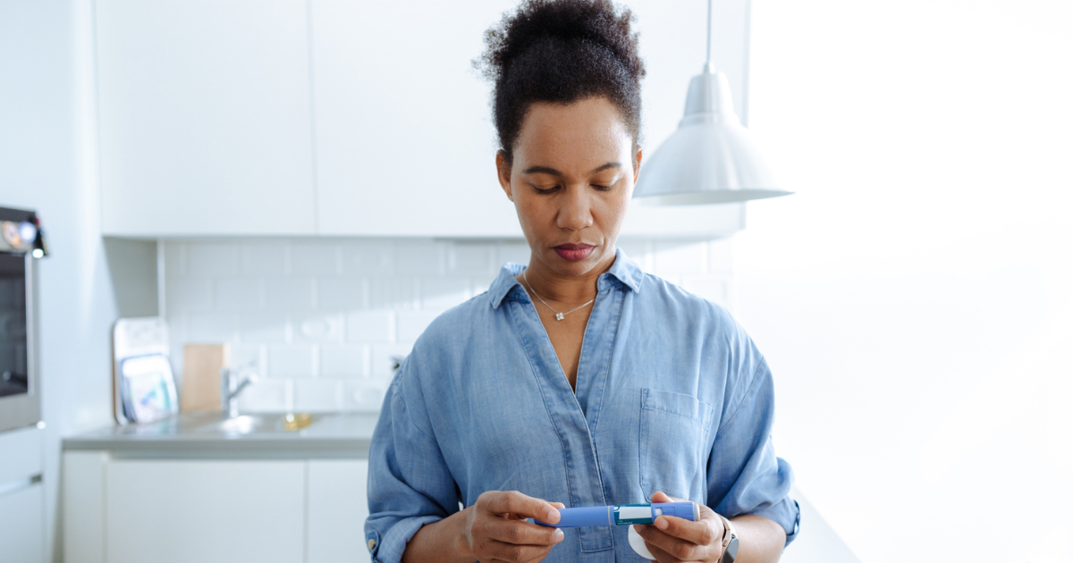 Woman holding GLP-1 injection