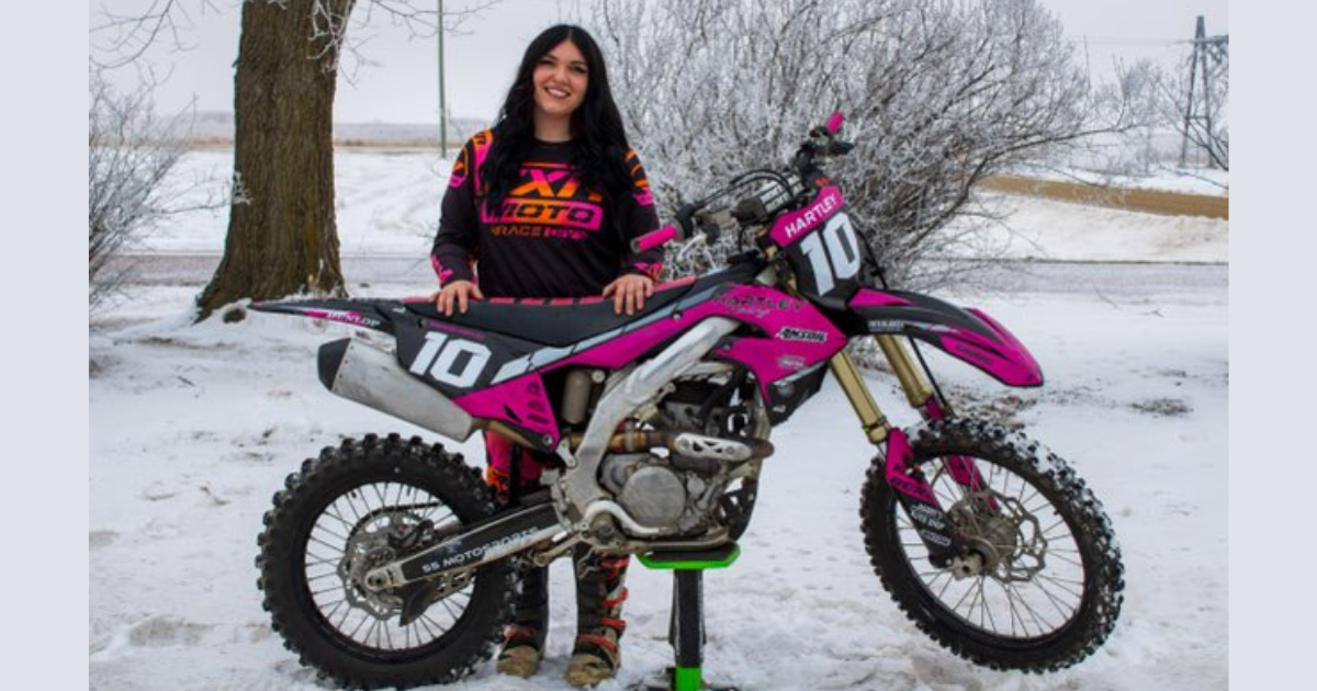 Raihanna Hartley standing with motorbike