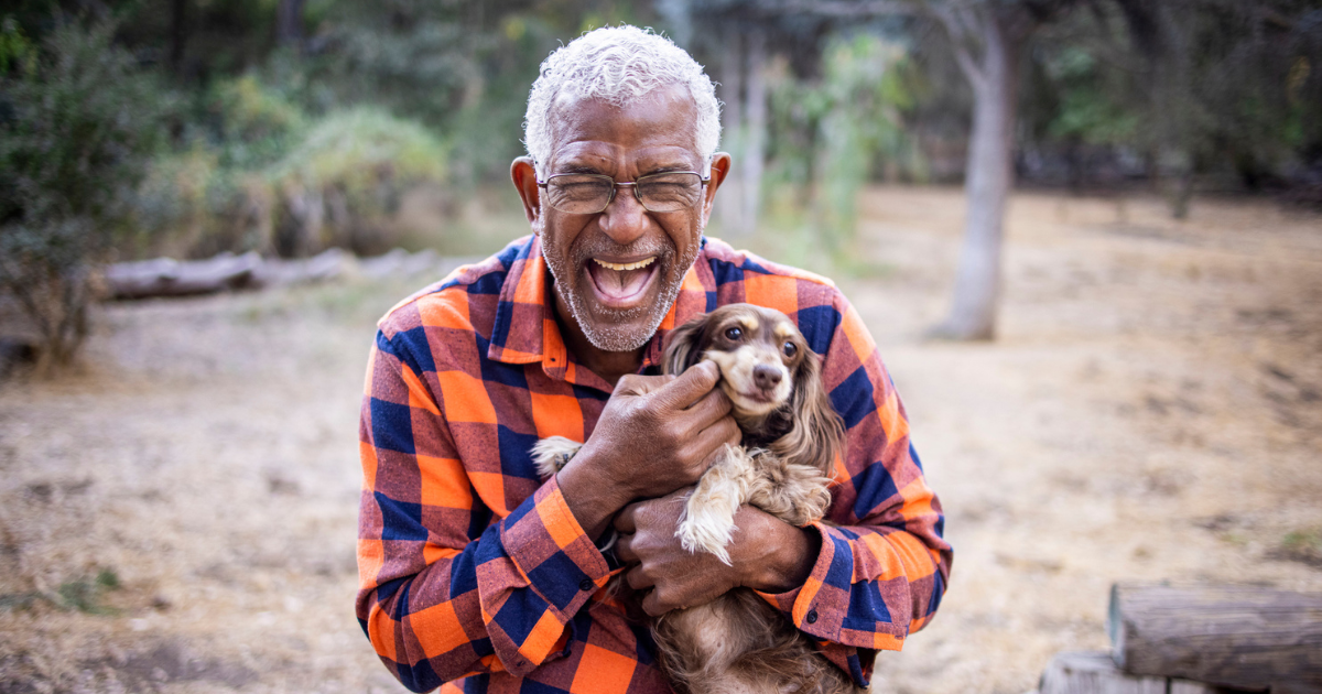 Man holding a dachshund