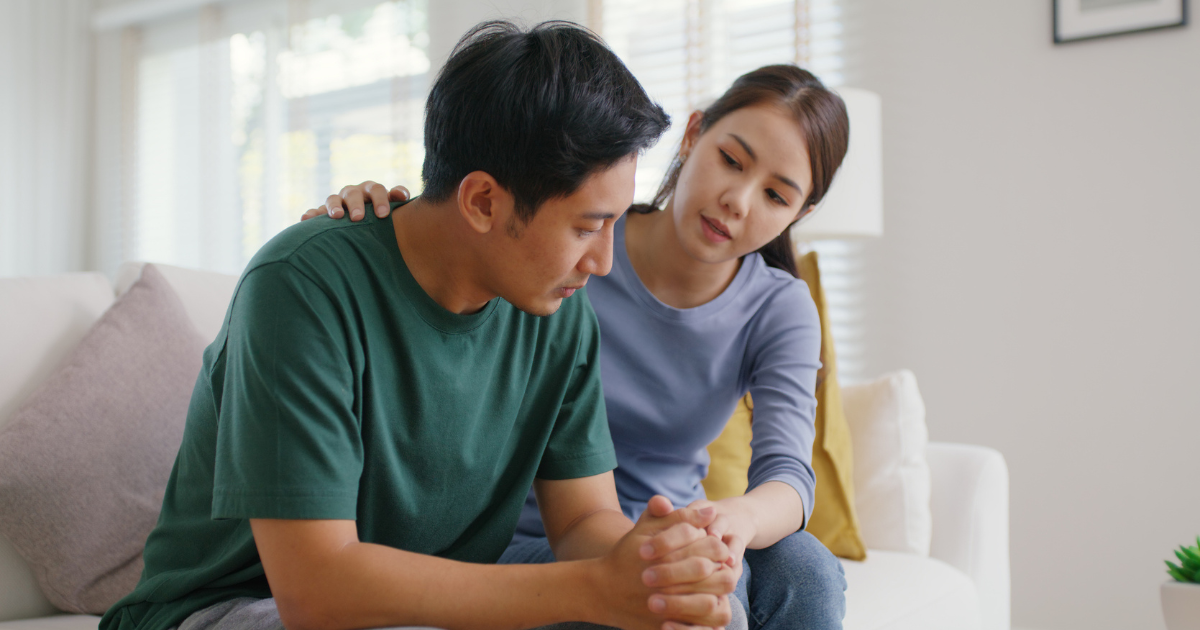 Man and woman sitting on couch