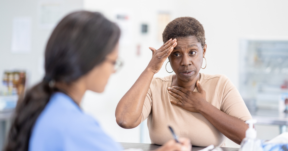 Woman talking to nurse about headache
