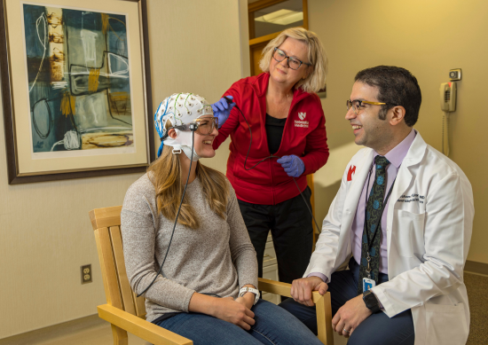Hesham Ghonim, MD and nurse adjusting MEG cap on patient