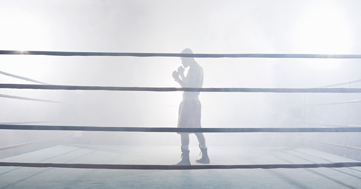 Boxer standing in a foggy boxing ring