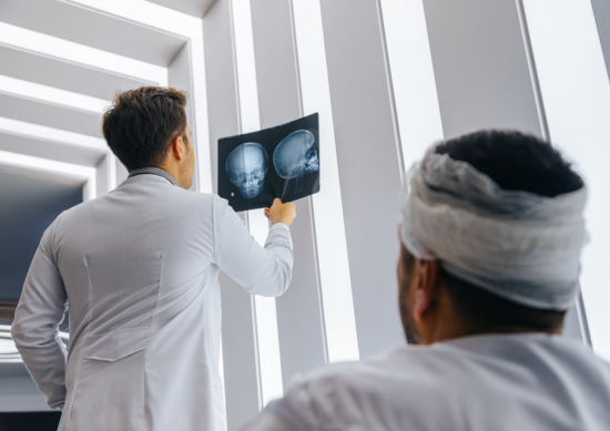 Doctor showing patient an xray of his skull