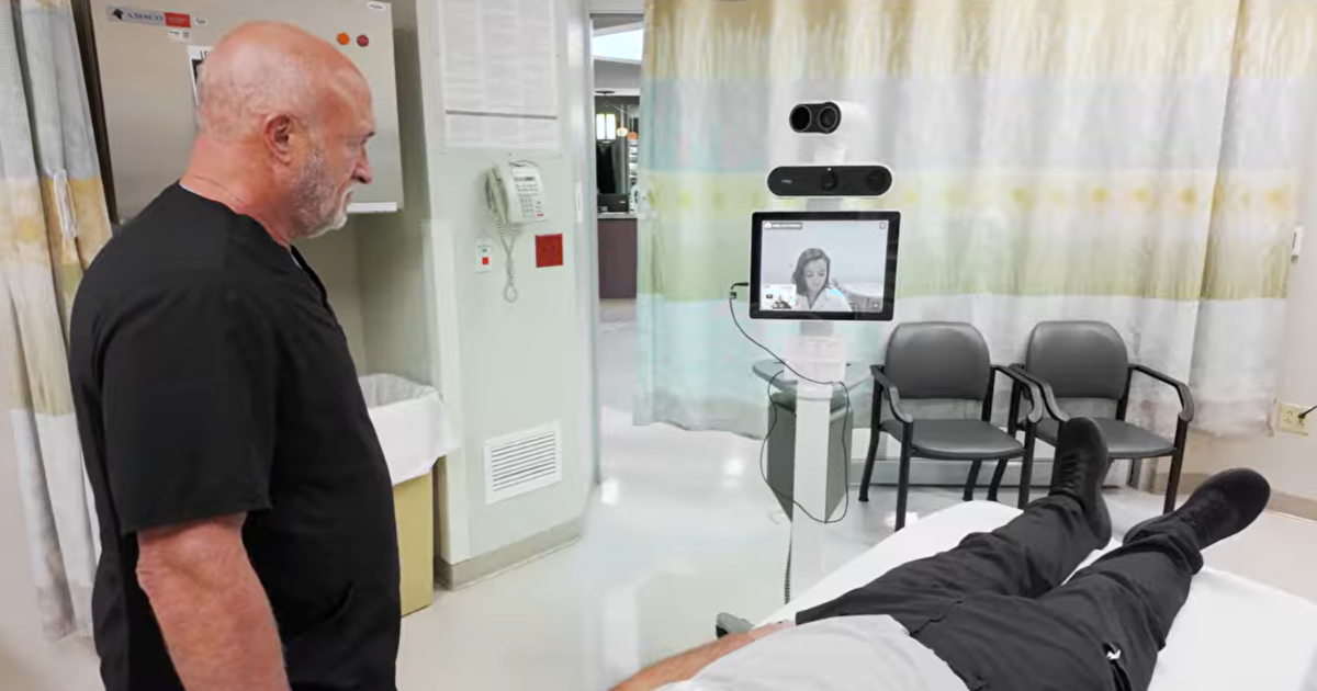 Steve Lapke, MD and patient Roger Vial speaking with Kelly-Ann Patrice, MD on video