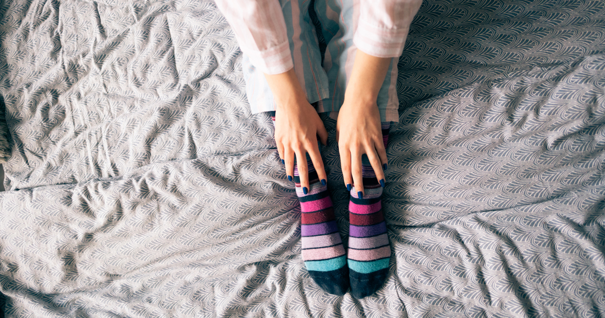 Close up of a woman's legs in bed