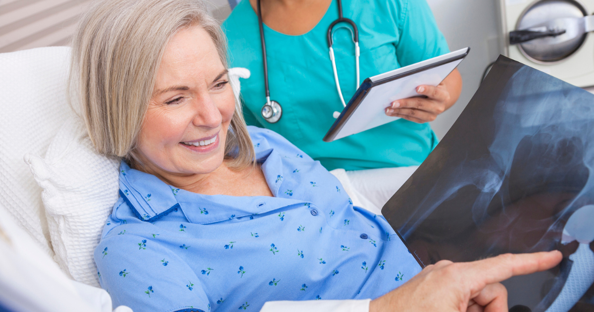 Older woman looking at x-ray of her hip replacement