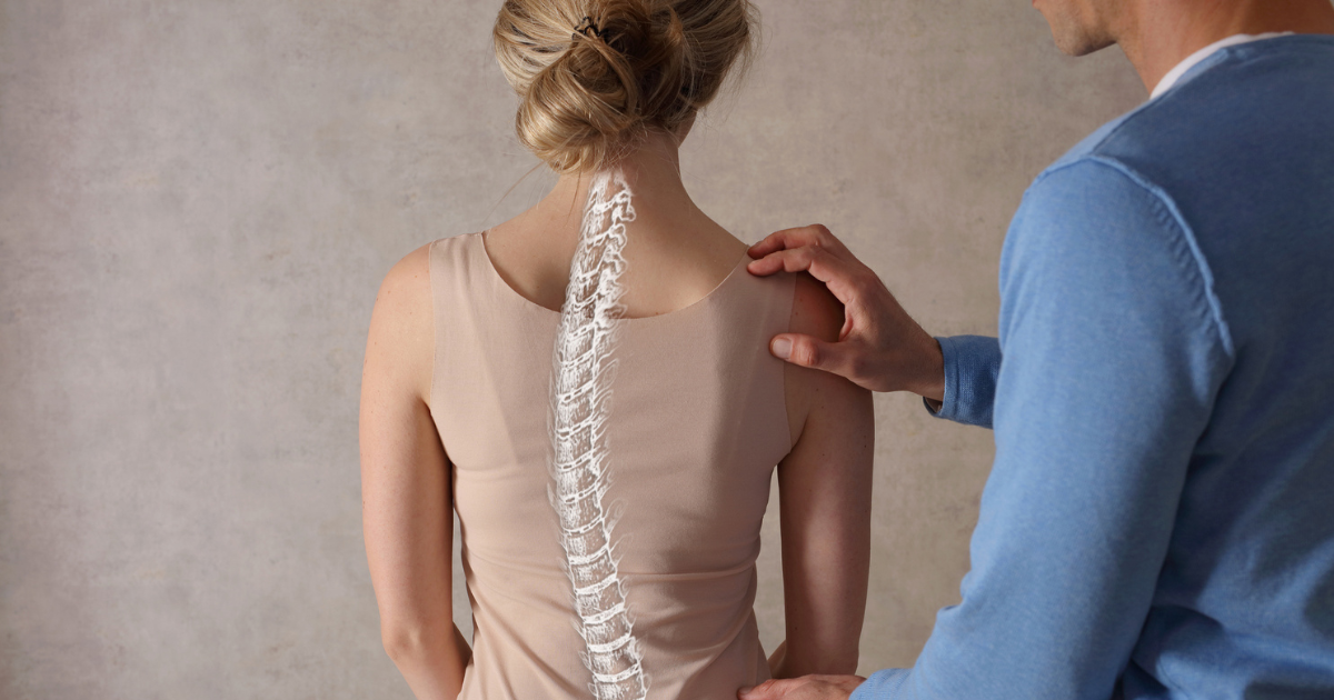 Provider examining woman's back with curved spine
