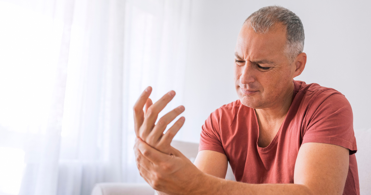 Man holding his hand in pain