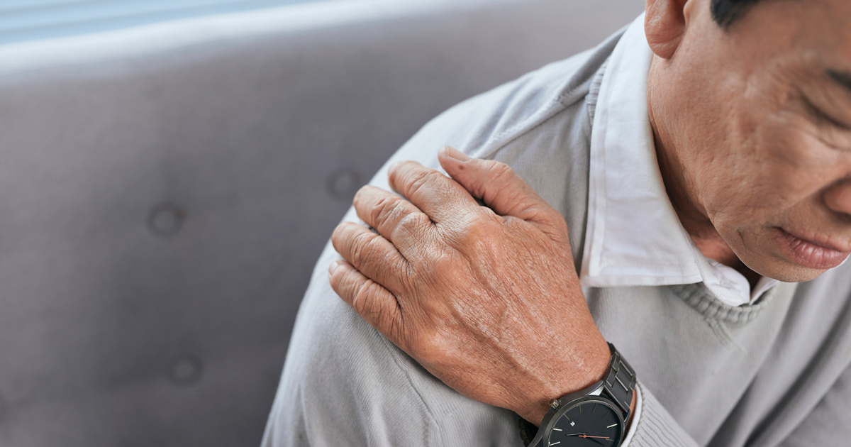 picture of a man holding his shoulder