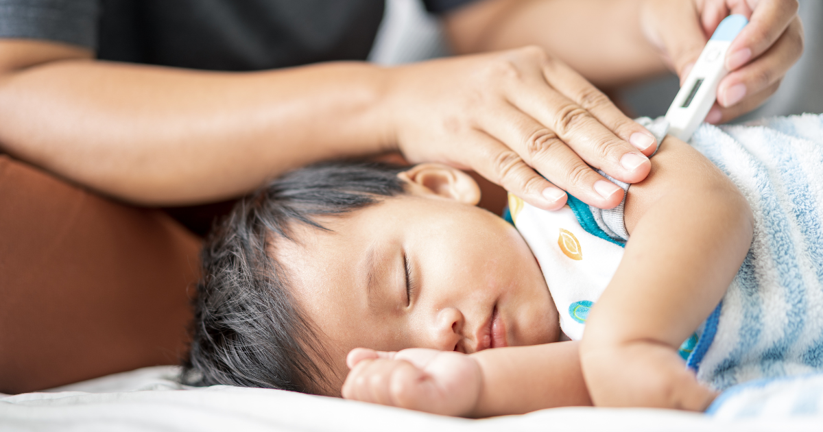 picture of an infant getting their temperature checked