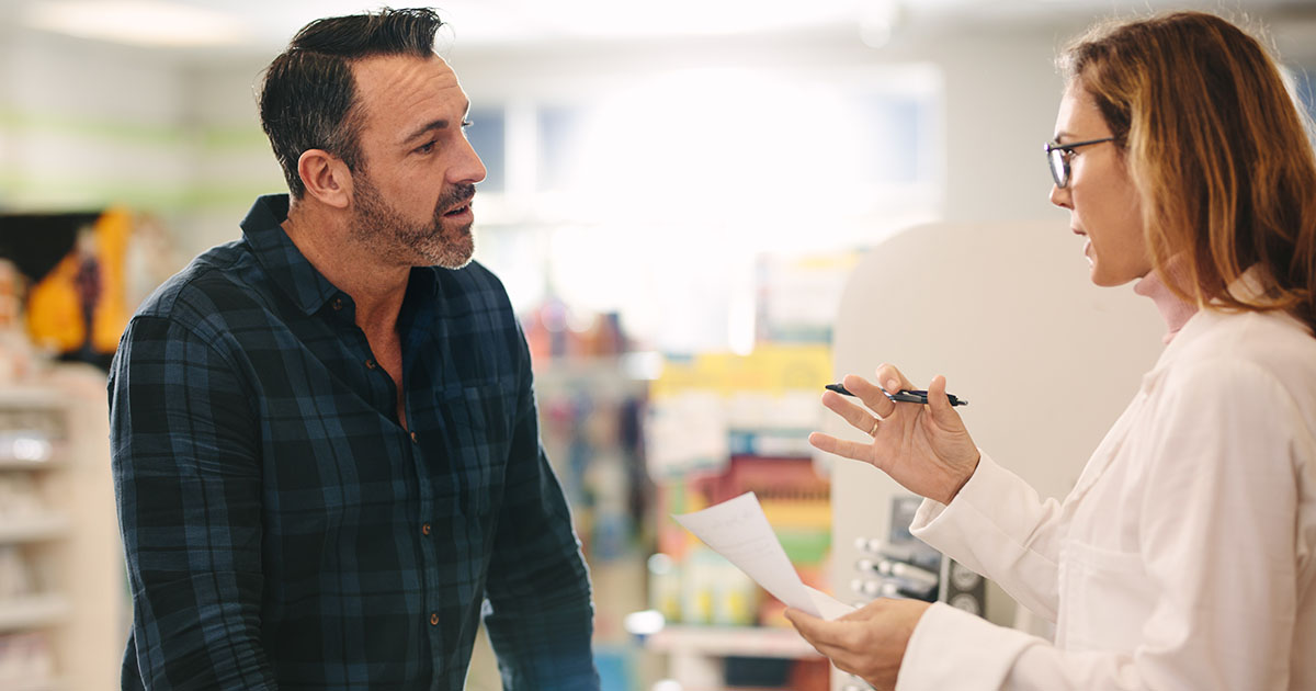 man talking to a pharmacist