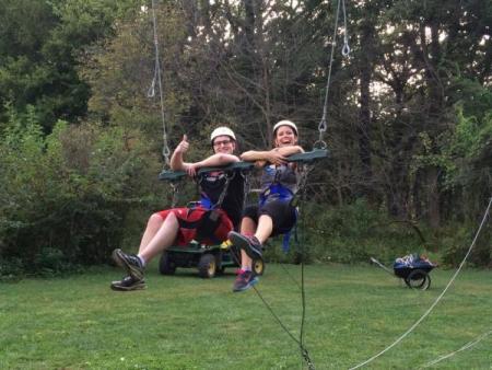 Man and woman sitting on a large swing