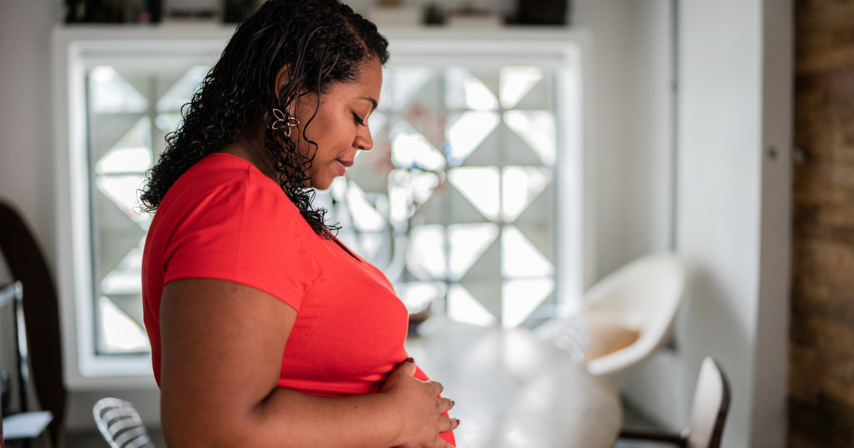 Pregnant woman touching her stomach