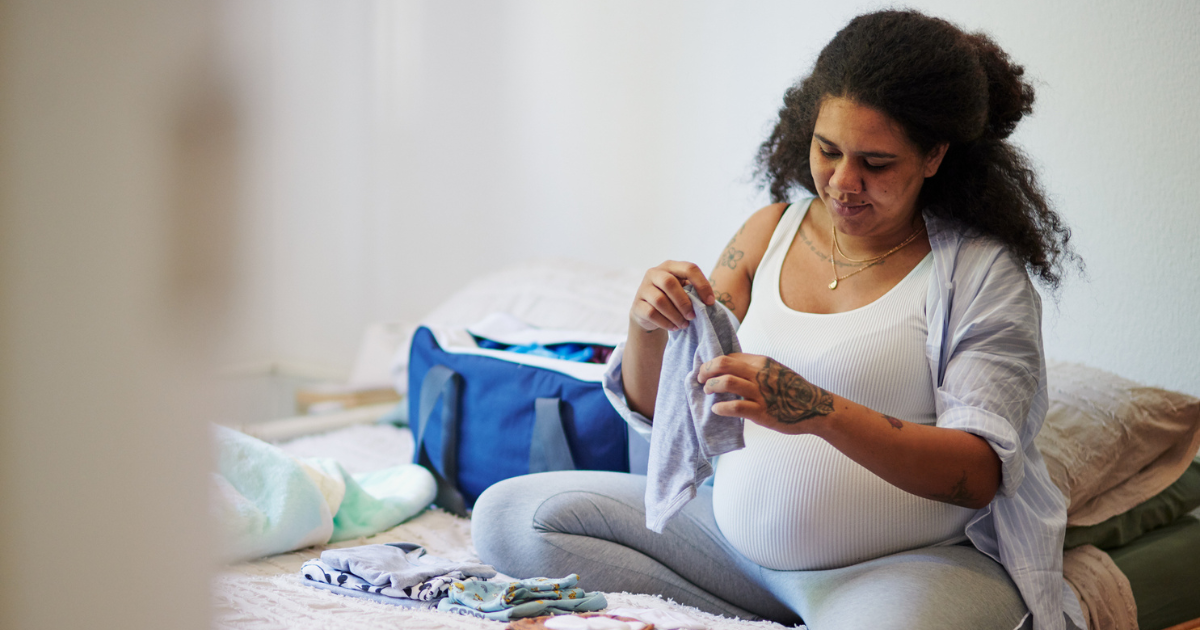 Pregnant woman packing a hospital bag