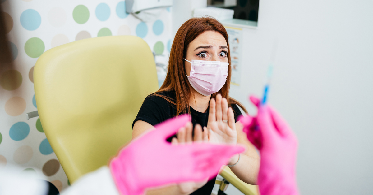 Woman in a clinic scared of needle 