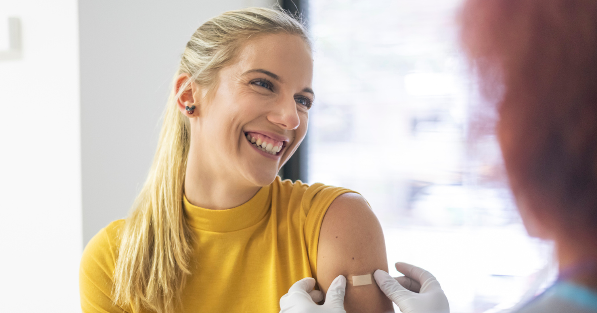 Smiling woman getting her flu shot