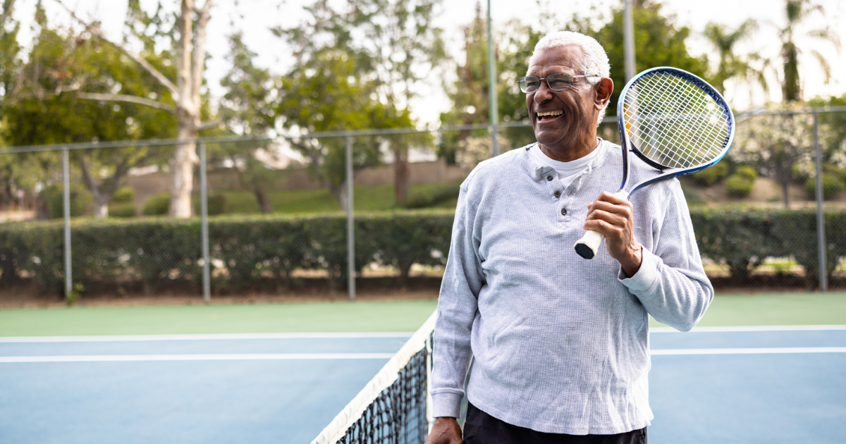 An older man playing tennis