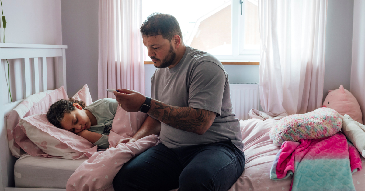 Dad taking daughter's temperature