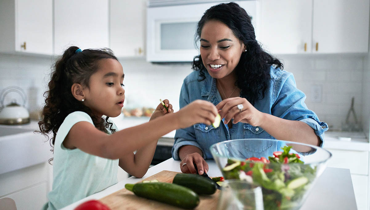 Mother and daughter making a salad