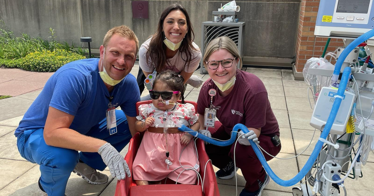 Doerneman, Lexi Albertsen, child life specialist, and Stehlik, pose for a picture with Genesis during a walk. 