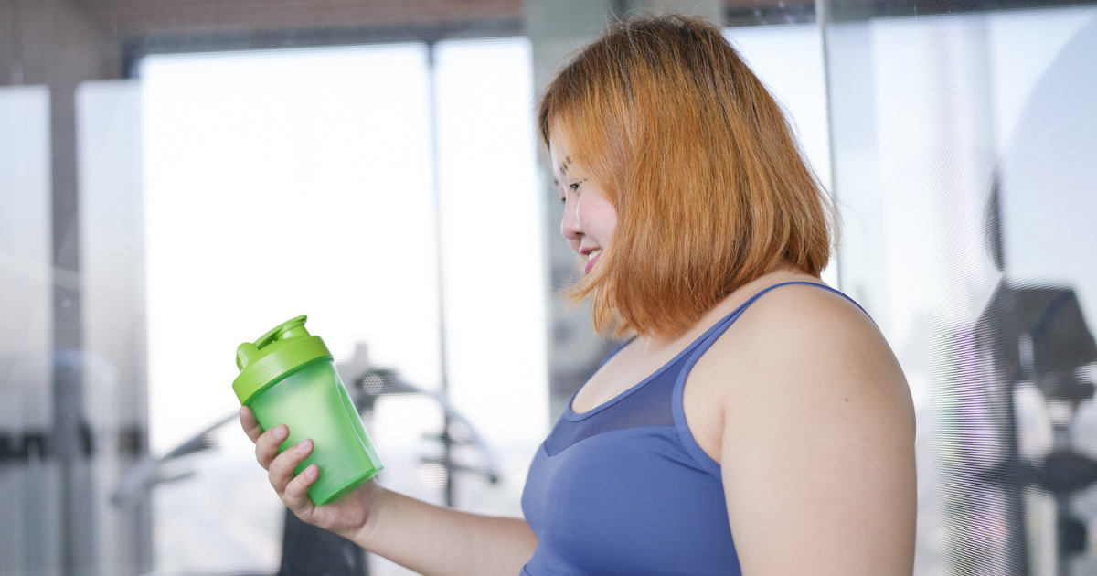 Woman holding protein shake