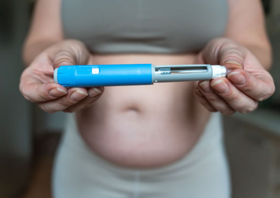 Close up of woman holding GLP-1 synringe