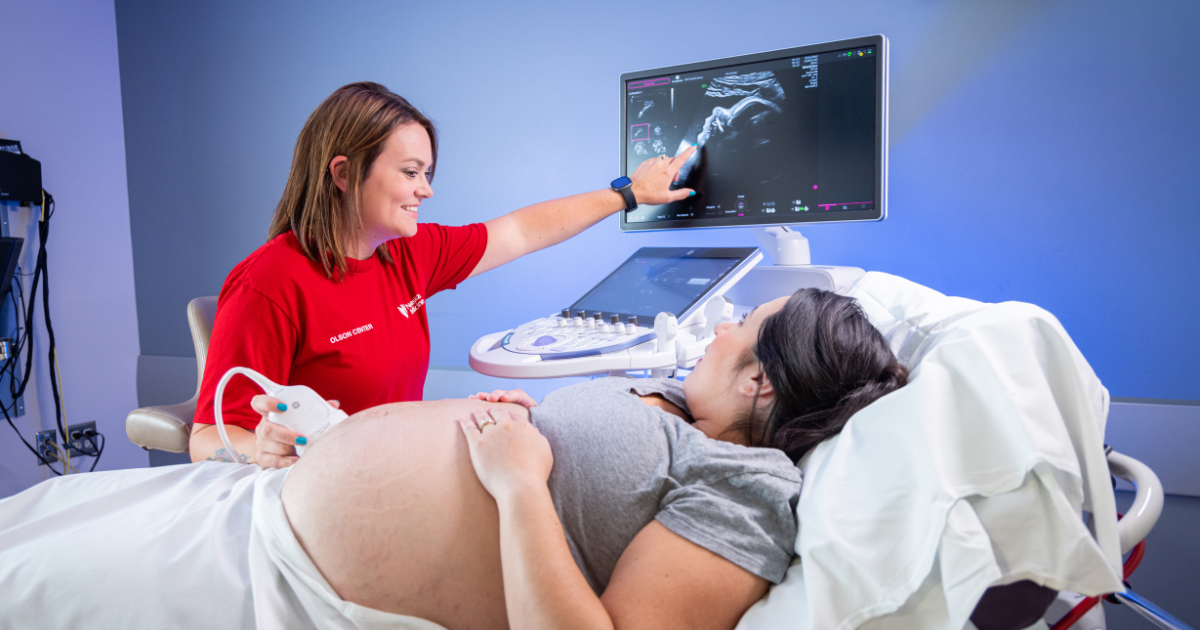NM sonographer performing ultrasound on pregnant patient